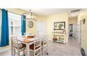 Dining area with a light wood table and coastal-themed decor at 26951 White Plains Way, Leesburg, FL 34748