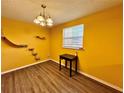 Bright yellow dining room with cat shelves and wood flooring at 4099 Dijon Dr # 4099H, Orlando, FL 32808