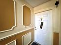 Condo entry with decorative molding and white door at 4099 Dijon Dr # 4099H, Orlando, FL 32808