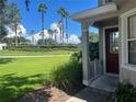 Townhome entrance with a red door and landscaping at 722 Chacall Loop, Mount Dora, FL 32757