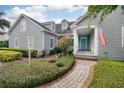 Gray house with a brick walkway and American flag at 818 Oak St, Orlando, FL 32804