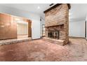 Living room with large brick fireplace and brown carpet at 202 Bedford Rd, Altamonte Springs, FL 32714