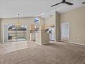 Kitchen with light wood cabinets, stainless steel appliances, and a breakfast bar at 2977 Kokomo Loop, Haines City, FL 33844