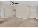 Spacious living room with carpeted floors and neutral walls at 2977 Kokomo Loop, Haines City, FL 33844