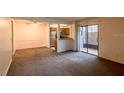 Spacious living room with carpet flooring and sliding glass door to patio at 3043 Antique Oaks Cir # 171, Winter Park, FL 32792