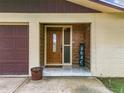 Inviting front entry with wood-paneled accent wall and tiled flooring at 2405 Boy Scout Rd, Apopka, FL 32703
