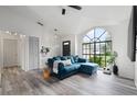 L-shaped sectional sofa and an arch window in the living room at 2921 Omaha Dr, Deltona, FL 32738