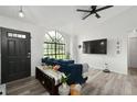 Living room with a large window, dark blue couch, and a TV at 2921 Omaha Dr, Deltona, FL 32738