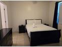 Bedroom with a queen-size bed, nightstands, and dresser at 14102 Indian Creek Dr, Kissimmee, FL 34759