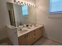 Bathroom with double vanity and large mirror at 14102 Indian Creek Dr, Kissimmee, FL 34759