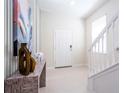 Bright and airy entryway with staircase and decorative accents at 4458 Kaipo Rd, Davenport, FL 33897