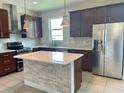 Modern kitchen with dark brown cabinets, white quartz countertops and stainless steel appliances at 2475 Hastings Blvd, Clermont, FL 34711