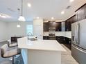 Modern kitchen with an island and stainless steel appliances at 1065 Blackwolf Run Rd, Davenport, FL 33896