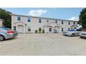 Three unit building exterior with parking in front at 210 Majors Ln # B, Kissimmee, FL 34743