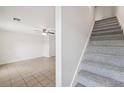 Interior stairs with grey carpet leading to the second floor at 210 Majors Ln # B, Kissimmee, FL 34743