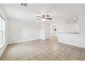 Open concept living room with tile flooring and ceiling fan at 210 Majors Ln # B, Kissimmee, FL 34743