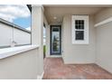 Brick paved back patio with access door and a view of the backyard at 523 Kennedy Dr, Lake Alfred, FL 33850