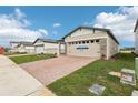 Single-Gathering home with landscaping and a brick driveway at 523 Kennedy Dr, Lake Alfred, FL 33850