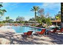 Community pool with lounge chairs and a pergola at 5467 Vineland Rd # 6308, Orlando, FL 32811