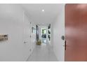 Bright condo entryway with tile floors and modern door at 241 Riverside Dr # 1901, Daytona Beach, FL 32117