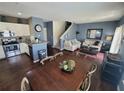 Open concept kitchen and dining area with hardwood floors and ample seating at 8959 Shine Dr, Kissimmee, FL 34747