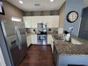 Modern kitchen featuring stainless steel appliances and granite countertops at 8959 Shine Dr, Kissimmee, FL 34747