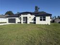 Newly constructed one-story home with a two-car garage and landscaped lawn at 2827 Sw 146Th Place Rd, Ocala, FL 34473