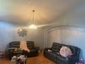 Living room with vaulted ceiling, two sofas, and hardwood floors at 4336 Cypress Bay Ct, Orlando, FL 32822