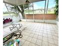 Spacious screened porch with tile flooring, overlooks backyard at 4336 Cypress Bay Ct, Orlando, FL 32822