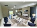 Bright living room featuring comfortable seating and a modern aesthetic at 2827 Sw 146Th Place Rd, Ocala, FL 34473