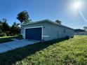 Side view of a single-story home with gray exterior and two-car garage at 13053 Sw 36Th Ct, Ocala, FL 34473