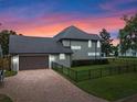Home's side view, showcasing garage and landscaping at 1451 Lyndale Blvd, Winter Park, FL 32789