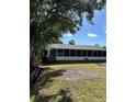 Back of house with screened porch and large yard at 3416 Unity Tree Dr, Edgewater, FL 32141