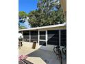 House side with screened porch and bikes at 3416 Unity Tree Dr, Edgewater, FL 32141