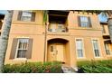 Townhouse exterior showcasing a front entrance and balcony at 2214 Calabria Ave, Davenport, FL 33897
