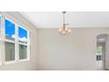 Bright dining room with large windows and a chandelier at 4814 Terra Sole Pl, St Cloud, FL 34771