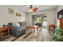 Living room with wood-look floors and comfy seating at 408 E Orlando Ave # 13A, Ocoee, FL 34761