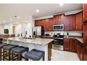 Modern kitchen featuring granite countertops and stainless steel appliances at 7513 Marker Ave, Kissimmee, FL 34747