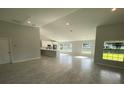 Open-concept living room with high ceilings and tile floors at 541 Rhodes Dr, Deland, FL 32720