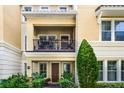 Townhouse with balcony, brown door and lush green landscaping at 3136 Porta Romano Way, Lake Mary, FL 32746