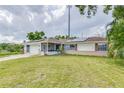 House exterior showcasing solar panels and a green lawn at 1522 Gainesville Dr, Deltona, FL 32725