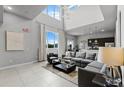 Modern living room with high ceilings, grey sectional sofa and kitchen at 7770 Sandy Ridge Dr # 208, Reunion, FL 34747