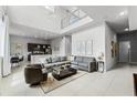 Open concept living room with high ceilings, sectional sofa and kitchen at 7770 Sandy Ridge Dr # 208, Reunion, FL 34747