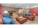Living room featuring a brick fireplace and comfortable leather furniture at 5006 Cub Lake Dr, Apopka, FL 32703