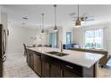Open concept kitchen with island, stainless steel appliances, and views to living area at 1224 Challenge Dr, Davenport, FL 33896