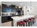 Modern kitchen with stainless steel appliances and an island with seating at 1224 Challenge Dr, Davenport, FL 33896
