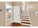 View of a staircase leading to the upper level of the home, with hardwood floors and a neutral color palette at 801 Lobelia Dr, Lake Mary, FL 32746