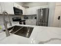 Modern kitchen with stainless steel appliances and white cabinets at 8020 Tuscany Way # 6103, Davenport, FL 33896