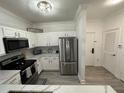 Modern kitchen with white cabinets and stainless steel appliances at 8020 Tuscany Way # 6103, Davenport, FL 33896