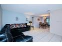 Spacious living room features a large sectional sofa and tile floors at 5924 White Egret Ln, Orlando, FL 32810